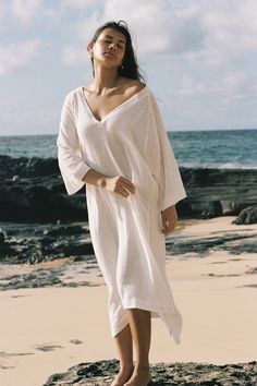 Our versatile cotton brings comfort and breathability in the Ajok Caftan. Designed to lounge in year-round, this classic silhouette features a plunging V-neckline, wide 3/4 sleeves and mid-length hem. Crafted from 100% cotton gauze. Layer over swimwear for any beach or poolside occasion. Classic Silhouette, Top Dress, Jewelry Bags, Hat Hairstyles, Sales Gifts, Mid Length, Mother's Day Gifts, Jumpsuit, Lounge