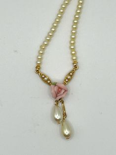 Capture timeless romance with this vintage necklace by Yesterday's Treasures. Faux pearls cascade alongside a delicate pink rose and gold tone metal, adding a touch of feminine charm to any outfit. Vintage Pink Pearl Necklaces, Vintage Pink Pearl Necklace, Vintage Rose Necklace For Wedding, Necklace Stack, Pink Pearl Necklace, Mother Of Pearl Jewelry, Pink Pearls, Vintage Necklaces, Pearls Necklace