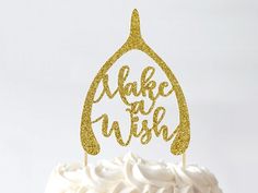 there is a cake that has been decorated with gold glitters and the words make a wish on it