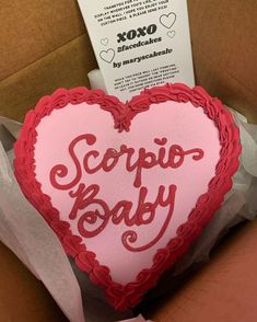 a heart shaped cake in a box with the words scripe baby written on it