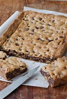 chocolate chip cookie bars cut into squares on a cutting board