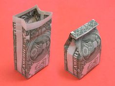 two pieces of paper with money sticking out of them on a pink background, one is folded in half and the other has been folded down