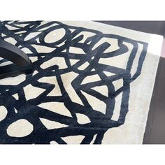 a black and white rug on top of a wooden table