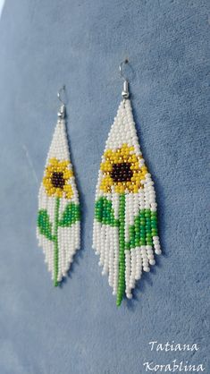 "These handmade unique earrings \"Sunflower\" are made of high-quality Czech beads and strong synthetic thread. I use my author's scheme . They are elegant, fashionable, and highly versatile, suitable for everyday wear. Color: white,yellow,brown,green . Copy without my permission is prohibited For those who want to buy my copyright scheme for these earrings: https://www.etsy.com/uk/listing/1056785837/brick-stitch-pattern-for-seed-bead?ref=shop_home_active_2 100% hand made with love! Measurements White Flower-shaped Jewelry With Sunflower Design, White Flower Jewelry With Sunflower Design, White Sunflower Design Flower Jewelry, White Dangle Flower Earrings With Colorful Beads, White Flower Dangle Earrings With Colorful Beads, Sunflower Dangle Earrings For Summer, Summer Sunflower Dangle Earrings, White Flower Shaped Beaded Earrings With Colorful Beads, White Beaded Adjustable Flower Earrings