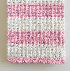 a pink and white crocheted dishcloth