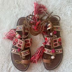 Sam Edelman Pink Maroon And Red Tassle Ankle Wrap Sandals. Gold Bling Decorations And Beige Needle Point Around Straps. These Are So So Cute , Love How They Wrap Up Your Ankle And Are The Tassels Are So Fun. Cute Colors, And Never Worn! Red Bohemian Sandals For Spring, Casual Sandals With Tassels And Round Toe, Closed Toe Sandals With Tassels For Spring, Leather Sandals With Tassels For Vacation, Festival Sandals With Tassels And Round Toe, Spring Sandals With Ankle Strap And Tassels, Red Flat Sandals For Festival, Cute Colors, Sandals Gold