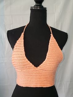 This crochet crop top ties around the neck as a halter top. It is peachy orange in color. This top measures 30 inches around the waist without being stretched. The yarn this top is made of is stretchy, and this top can fit sizes medium-large. This top does not have supportive cups or wiring built in. Peachy Orange, Crochet Halter, Crochet Crop, Diy Clothing, Cropped Tube Top, Crochet Crop Top, Halter Crop Top, Tube Top, Halter Top