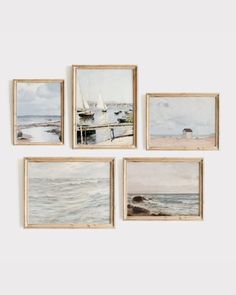 four framed paintings depicting boats on the water and one with sailboats in the background