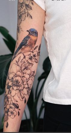 a woman with a bird tattoo on her arm