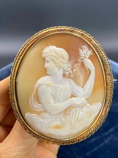 Large Victorian 18K Gold Shell Roman Lady Cameo Brooch  A hand made, tooled and raised filigree bordered frame. Unmarked, tested for 18K+ gold. XRF Machine tests it as closer to 21K Gold. Weight: 30.8 grams. Dimensions: 7cm long x 6.2cm wide (Including frame) Condition: Minor crazing Minimal surface wear. Thank you for supporting our small business. Feel free to message us for any additional details or questions. Please follow us on Instagram for our latest finds. @alife.collected Traditional Yellow Gold Collectible Brooch, Luxury Gold Brooches With Intricate Design, Luxury Intaglio Brooch For Formal Occasions, Carved Oval Brooch For Formal Occasions, Carved Oval Brooch For Formal Wear, Ornate Oval Intaglio Brooches, Luxury Oval Intaglio Brooches, Carved Oval Brooches For Formal Wear, Luxury Cameo Brooches