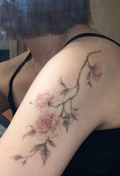 a woman's arm with flowers on it