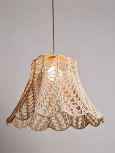 a crocheted lamp shade hanging from a ceiling