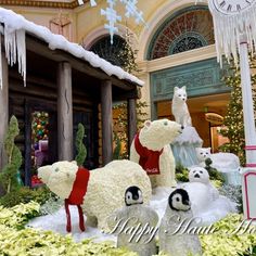 there are polar bears and penguins in this christmas display at the mall with snow on them