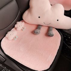 a pink car mat with two stuffed animals on it