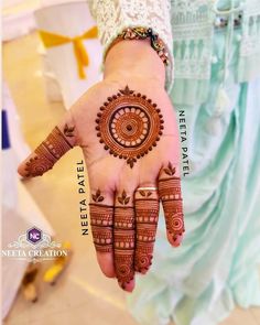 a woman's hand with henna tattoos on it