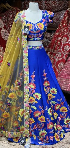 Royal blue summer blossom pattern with colorful flowers hand embroidered patchwork design lehenga. Available with matching embroidered blouse and contrasting light yellow embroidered net dupatta. All you need to slay that perfect look and this is how! Fabric : Silk Size: 38 Ready to Ship! Bollywood Style Multicolor Sets With Intricate Embroidery, Multicolor Lehenga With Intricate Embroidery For Festive Occasions, Multicolor Embroidered Lehenga For Designer Wear, Designer Multicolor Lehenga With Intricate Embroidery, Designer Multicolor Embroidered Lehenga, Fitted Sharara With Multicolor Floral Embroidery, Multicolor Designer Sets With Intricate Embroidery, Multicolor Embroidered Designer Sets, Multicolor Embroidered Lehenga With Traditional Drape