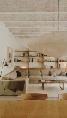 a living room filled with furniture and bookshelves