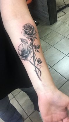 a person with a rose tattoo on their arm