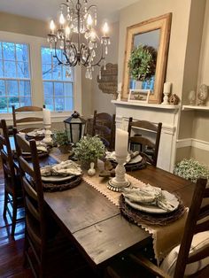 the dining room table is set with place settings