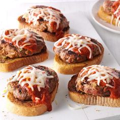 mini meatball sandwiches with sauce and cheese on top