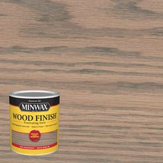 a can of wood finish sitting on top of a wooden table