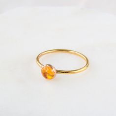 Our dainty birthstone ring features a natural Citrine gemstone in a 14k gold-filled or sterling silver setting. Citrine is the birthstone for those born in November. …………………………………. DETAILS •STONE Citrine measuring 5mm•BAND is 14k Gold Filled or .935 Argentium Silver •WATERPROOF and can be worn all-day •SIZE INCLUSIVE and made to order Don't know your ring size? Ring Size Guide or Buy Ring Sizer