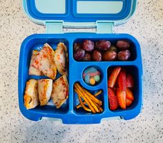 a blue lunch box filled with different types of food