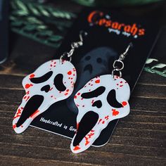 These unique Bloody Ghost Killer horror earrings are lightweight and perfect if you love to stand out from the crowd! They add a dark and spooky look to any outfit! They're the perfect little gift for your spooky friend or yourself😉!Approximately 1" x 3" in length (including hook)All Jewelry is made with skin-friendly metal alloy hooks (nickel-free & lead-free!) Black Halloween Costume Party Earrings, Halloween Novelty Jewelry For Cosplay, Halloween Cosplay Novelty Jewelry, Black Earrings For Halloween Cosplay, Black Halloween Cosplay Earrings, Halloween Themed White Earrings, Fun Black Halloween Jewelry, Fun Black Jewelry For Halloween, Spooky White Earrings For Halloween