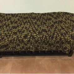 a couch that is made out of some sort of fabric on top of tile flooring