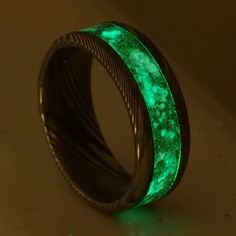 "When a customer ordered a custom twist Damascus band with a black, purple and blue color scheme, I knew I wanted to design the ring myself. Anytime there's a mix of colors with a black glow powder as the base, I think of the deep space style. The goal of the deep space style is to have the colors show subtly through t Glow In The Dark Black Jewelry For Gift, Glow Stones, Obsidian Jewelry, Damascus Ring, Carbon Fiber Rings, Damascus Steel Ring, Crushed Diamonds, Nebulas, Space Style