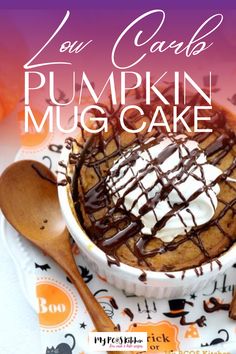 a pumpkin mug cake with whipped cream and chocolate drizzled on top in a white bowl