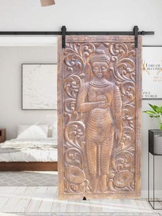 an ornate wooden door in the middle of a room with white walls and flooring