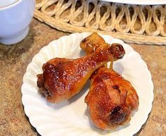 two pieces of chicken sitting on top of a white plate