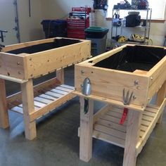 two wooden raised planters sitting on top of a floor next to each other in a garage