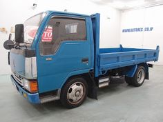 a blue truck is parked in a garage