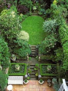 an aerial view of a garden with lots of greenery and benches in the middle