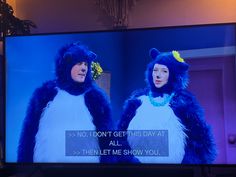 two people dressed in blue and white costumes on a television screen with the words, no i don't get this day at all then let me show you