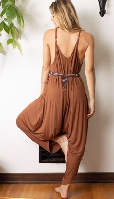 Easy-to-wear jumpsuit is one-size-fits-all with straps that can be adjusted for length. Beautiful earth tone color to complement your closet! Soft material is perfect for rolling up and stowing in your suitcase. Flowing fabric makes inversions fun! Another fun way to wear this style is adjust the steps to the biggest & criss cross at the neck. Great styled solo, layered over leggings or under a cropped jacket paired with chunky heeled mules. One size fits most fits 0-14. Jersey Knit blend to giv Brown Summer Jumpsuits And Rompers For Loungewear, Summer Brown Jumpsuits And Rompers For Loungewear, Sleeveless Brown Jumpsuits And Rompers For Beach, Brown Sleeveless Jumpsuits And Rompers For Vacation, Sleeveless Brown Jumpsuit For Beach, Brown Sleeveless Jumpsuit For Vacation, Sleeveless Brown Jumpsuit For Vacation, Sleeveless Brown Jumpsuit For The Beach, Jumpsuit With Pockets