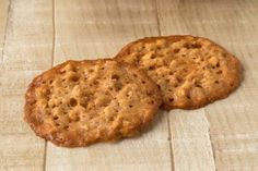 two cookies sitting on top of a wooden table