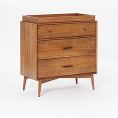 a wooden dresser with three drawers and two handles on the bottom drawer, against a white background