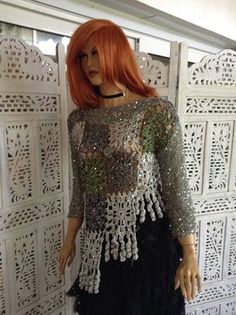 a mannequin wearing a black dress with silver sequins