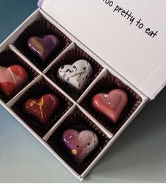 a box filled with assorted chocolates sitting on top of a table