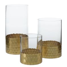 three glass vases sitting next to each other