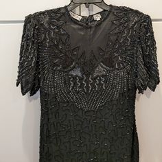 Black, Elegant Beaded Dress For A Formal Wedding Event Or Roaring Twenties Ball. Has Cap Sleeve Bodice And Intricate Embellishment Throughout. The Full-Length Skirt Has A Unique, Zig Zag Seam. Never Worn After Purchasing (Vintage) As It Was A Little Too Slim For My Bust. Please Reach Out With Questions Or Reasonable Offer. Thank You. Roaring 20s, Black Tie, Petite Black Sequin Flapper Dress For Wedding, Elegant Fitted Floor-length Flapper Dress, Elegant Beaded Flapper Evening Dress, Elegant Beaded Flapper Dress, Beaded Fitted Flapper Dress For Wedding, Elegant Formal Floor-length Flapper Dress, Embellished Gatsby Style Formal Dress, Gatsby Style Embellished Formal Dress, Formal Gatsby Embellished Dress