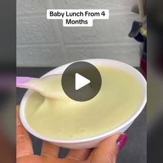 baby lunch from 4 months in a white bowl with spoon and pink nail polish on it