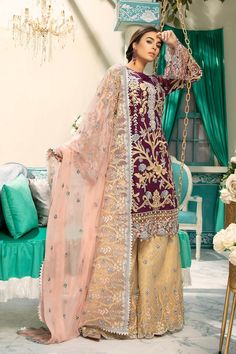 In love with this latest style plum chiffon suit with beautiful bottom, paired with luxurious shirt covered with elegant neckline and soft tea pink dupatta, Style with heavy jewelry and you are set to go any formal event. Top: Plum chiffon suit has fully embroidered chiffon shirt decorated with colorful floral bunches, intricate neckline, Sequins, embroidered cutwork daman and sleeves. Hanging crystal encrusted on daman. Attached with high quality inner. Dupatta: This beautiful plum chiffon suit Pakistani Eid Outfits, Pakistani Design, Net Sleeves, Chiffon Suit, Net Shirt, Eid Outfit, Eid Outfits, Pakistani Designer Suits, Pakistani Salwar Kameez