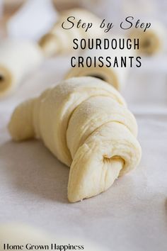 a close up of dough on a table with the words step by step sourdough croissants