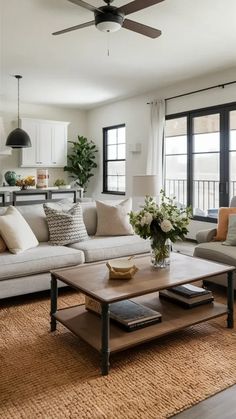 a living room filled with furniture and a ceiling fan in the middle of the room