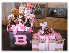 two gift boxes with teddy bears and other items in them sitting on a kitchen counter