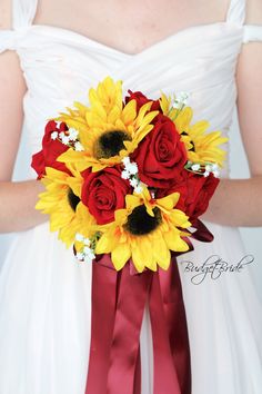 a bridal bouquet with sunflowers and red satin ribbons on the bride's dress